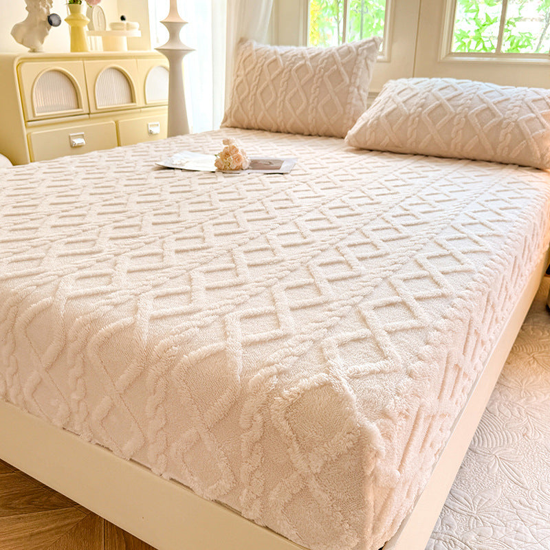 Beige textured bedspread on a bed in a bedroom setting